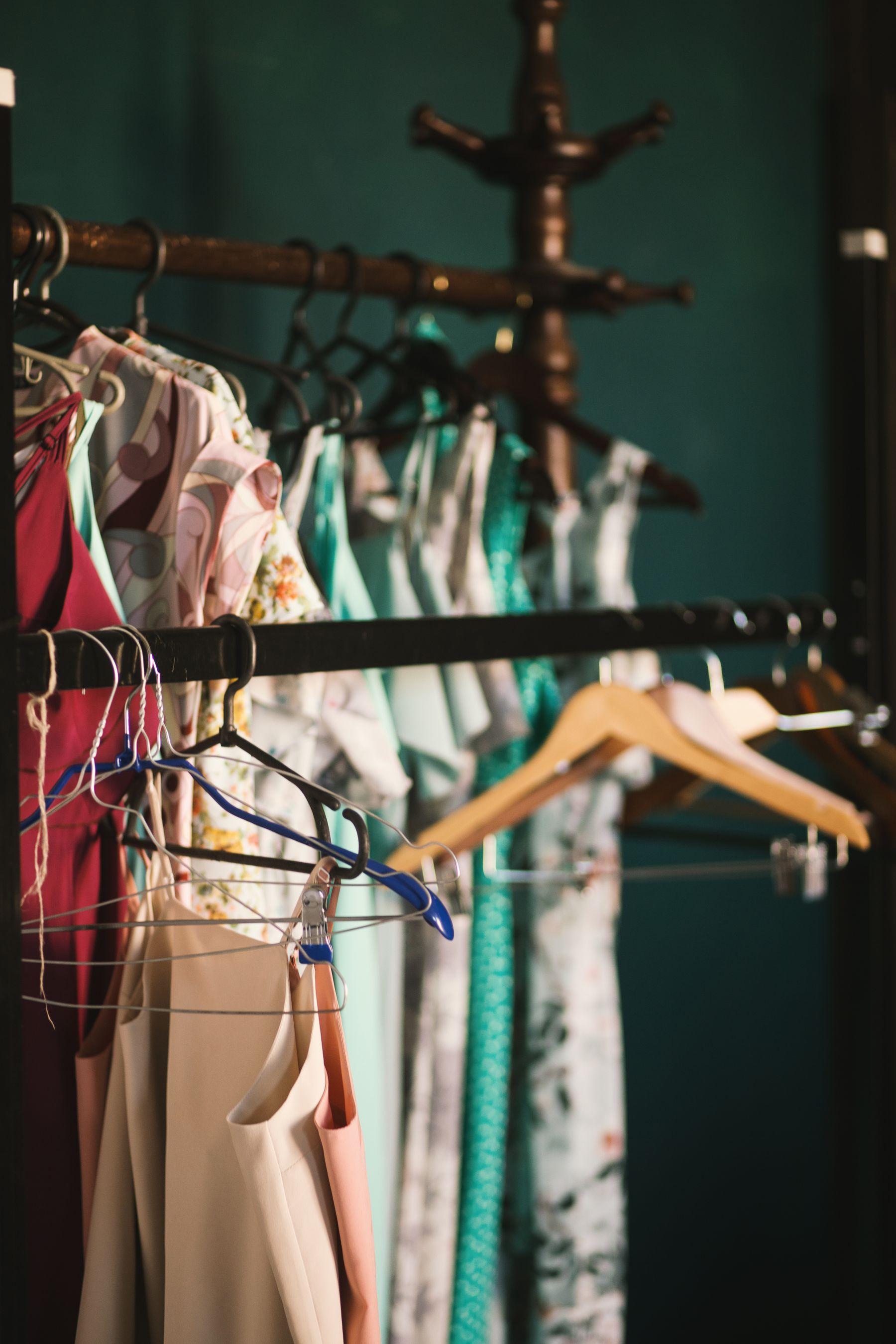 Ladies garments on wooden hangers on a rack